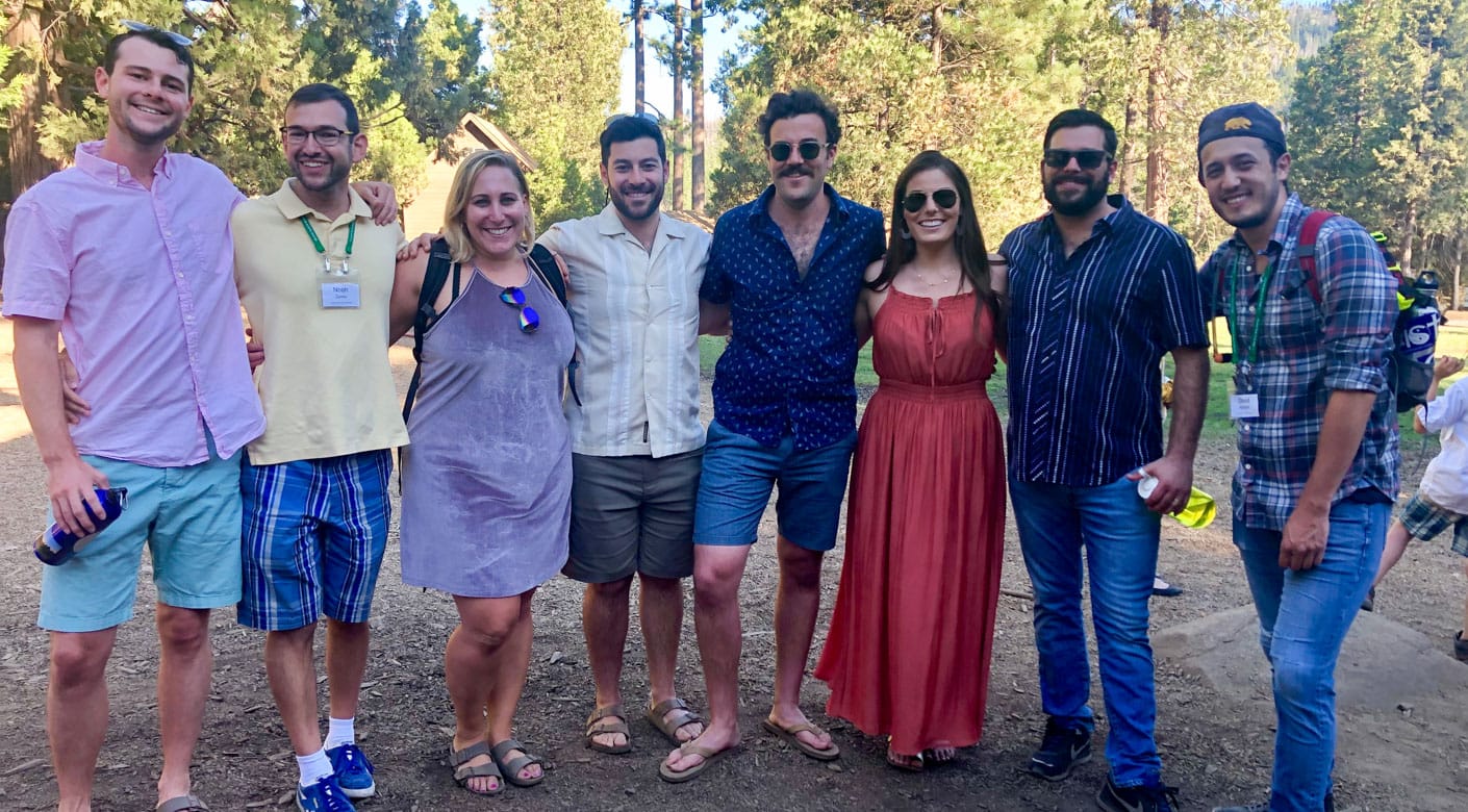 Group of alumni smiling at Camp Tawonga