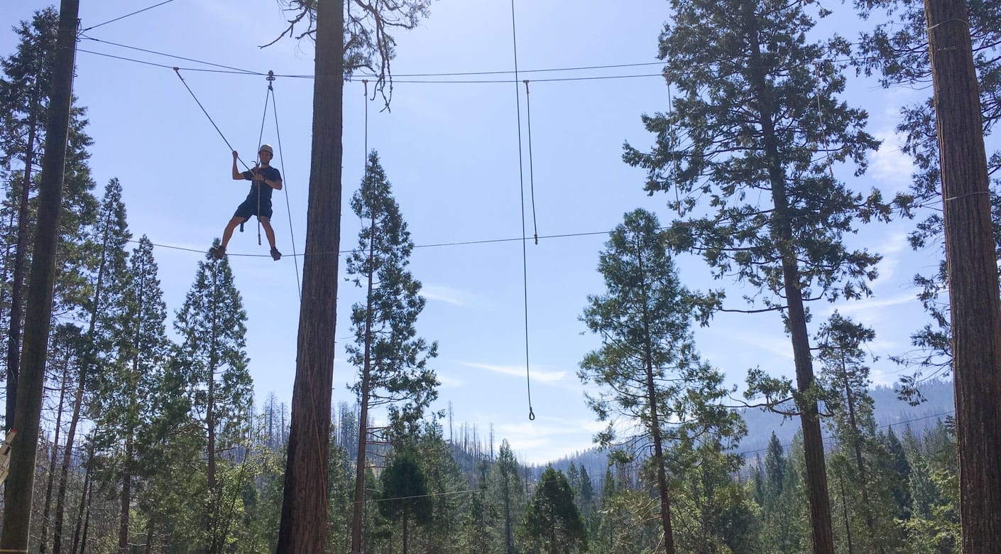 Alumni on the high ropes course at Camp Tawonga