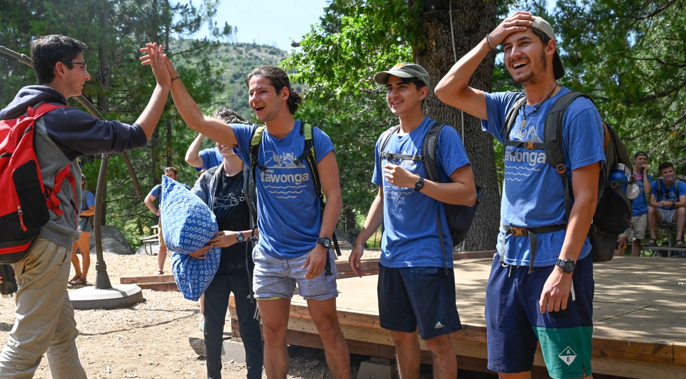 Staff giving a camper a high five