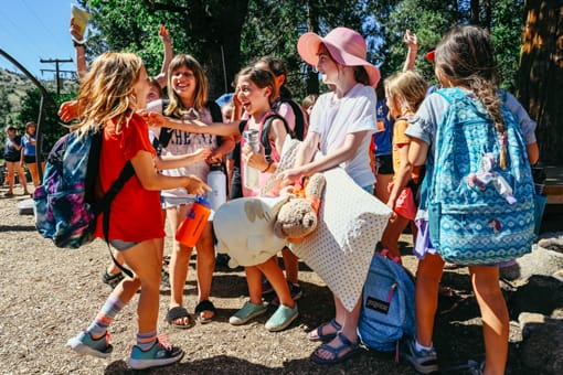 Girls at the first day of camp greeting each other