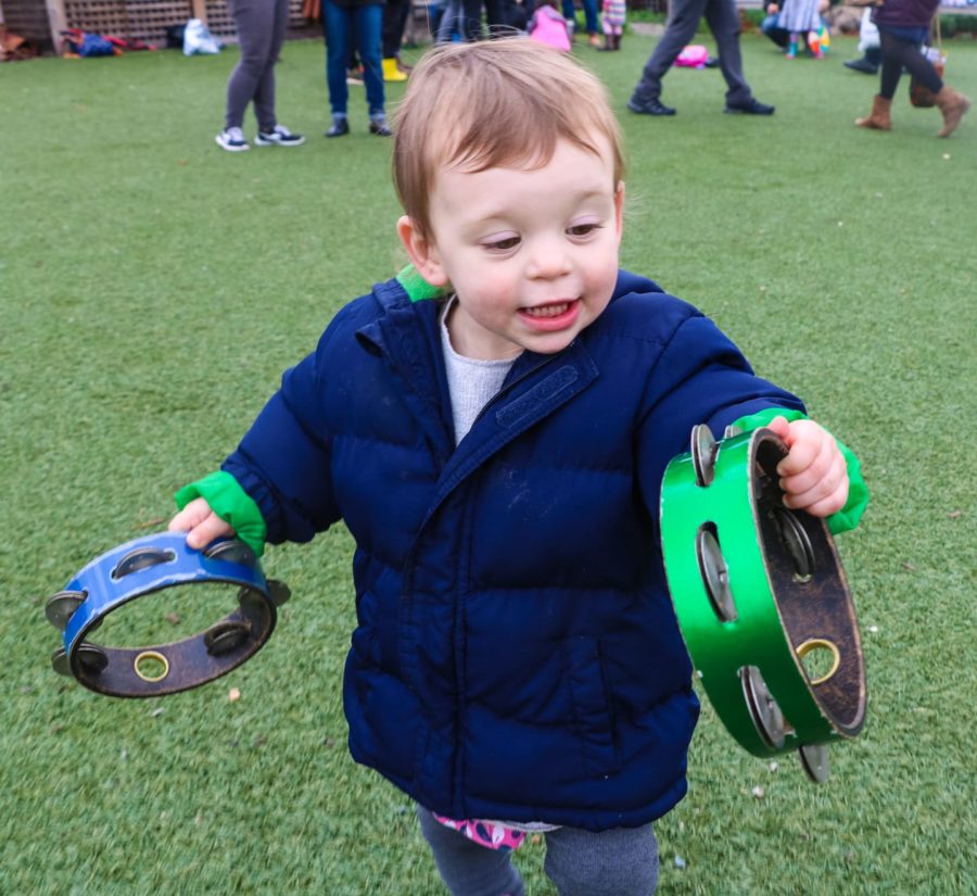 Kid playing music at Tot Shabbat