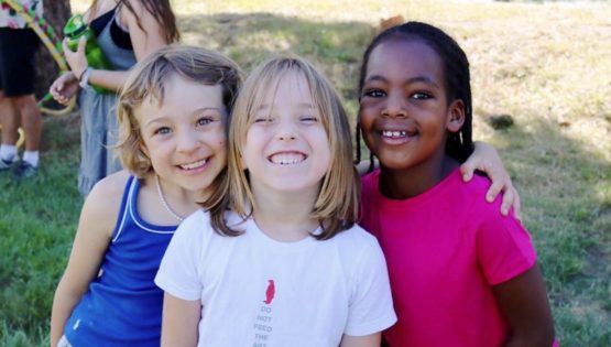Three young girls smiling