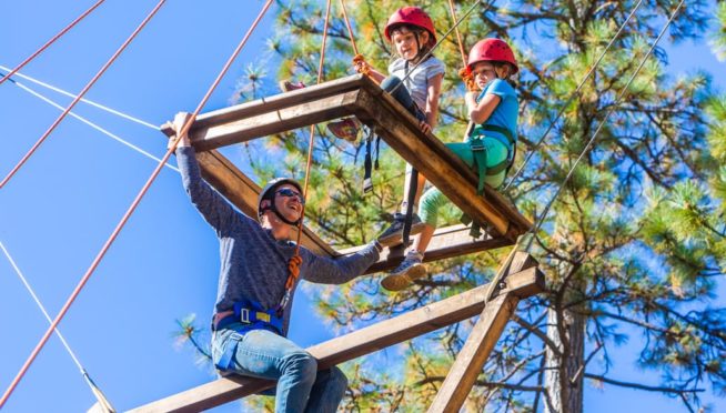 Family on ropes course during family camp
