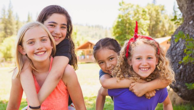 Girls giving each other piggyback rides