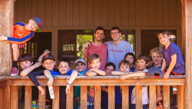 Boys on cabin porch smiling
